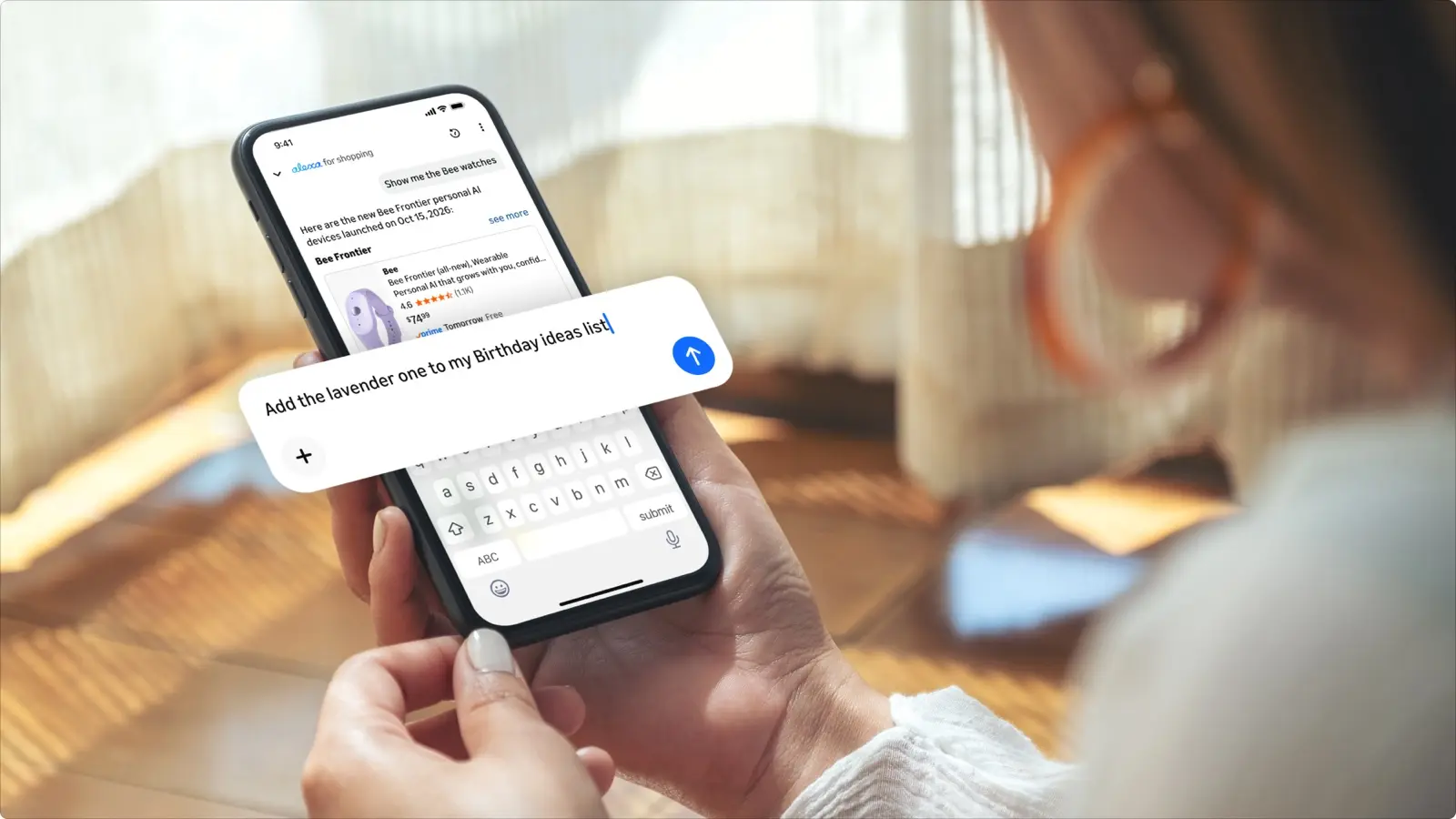 A person holds a phone showing an Alexa for Shopping chat, with a list request typed over the screen.
