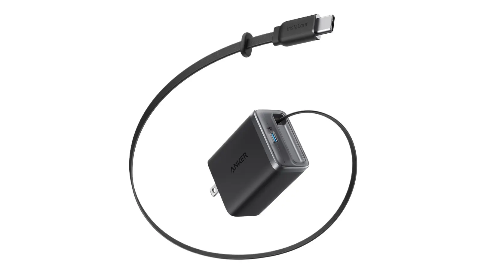 A black Anker Nano 35W charger with its flat USB-C cable pulled out in a wide loop around it, the USB-C plug at the top.