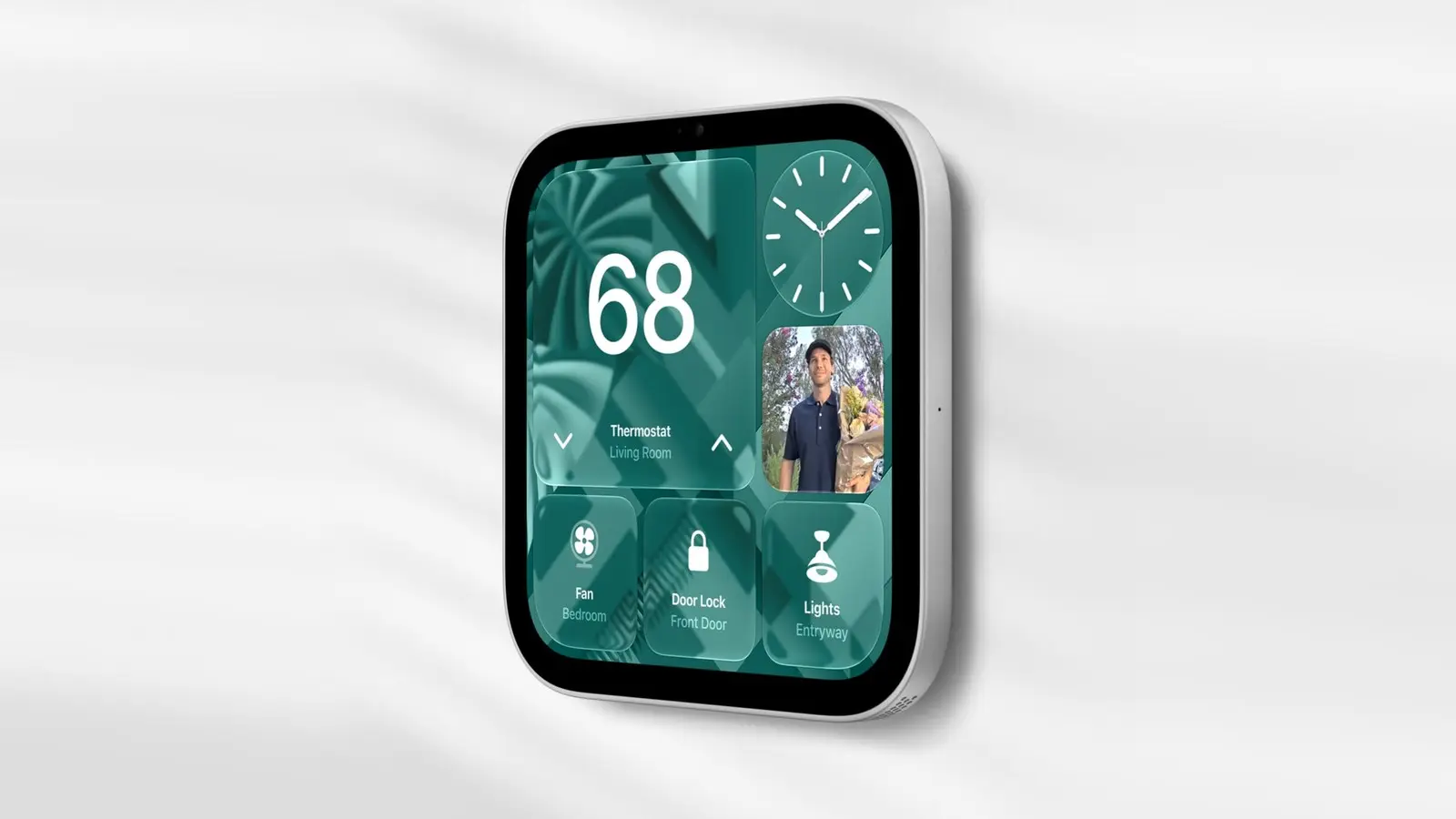 A wall-mounted Apple HomeView on a white wall, its screen showing a thermostat set to 68, a clock, a photo, and fan, door lock and lights tiles.