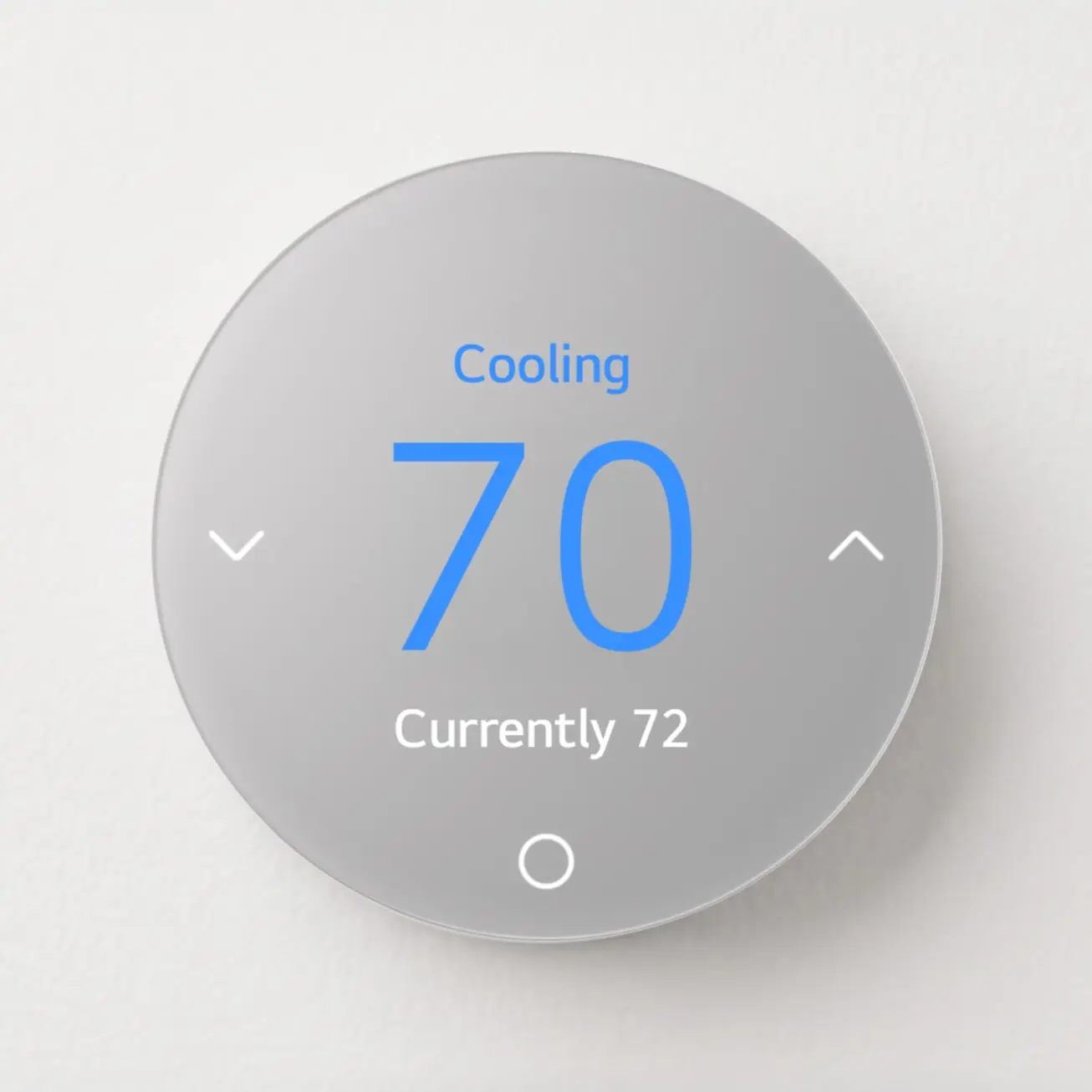 A round silver LG thermostat on a white wall showing Cooling, a 70 setpoint and a current reading of 72.