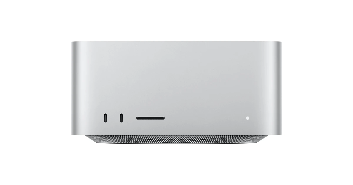 Apple's Mac Studio desktop in silver on a white background, shown from the front with its ports and perforated base.