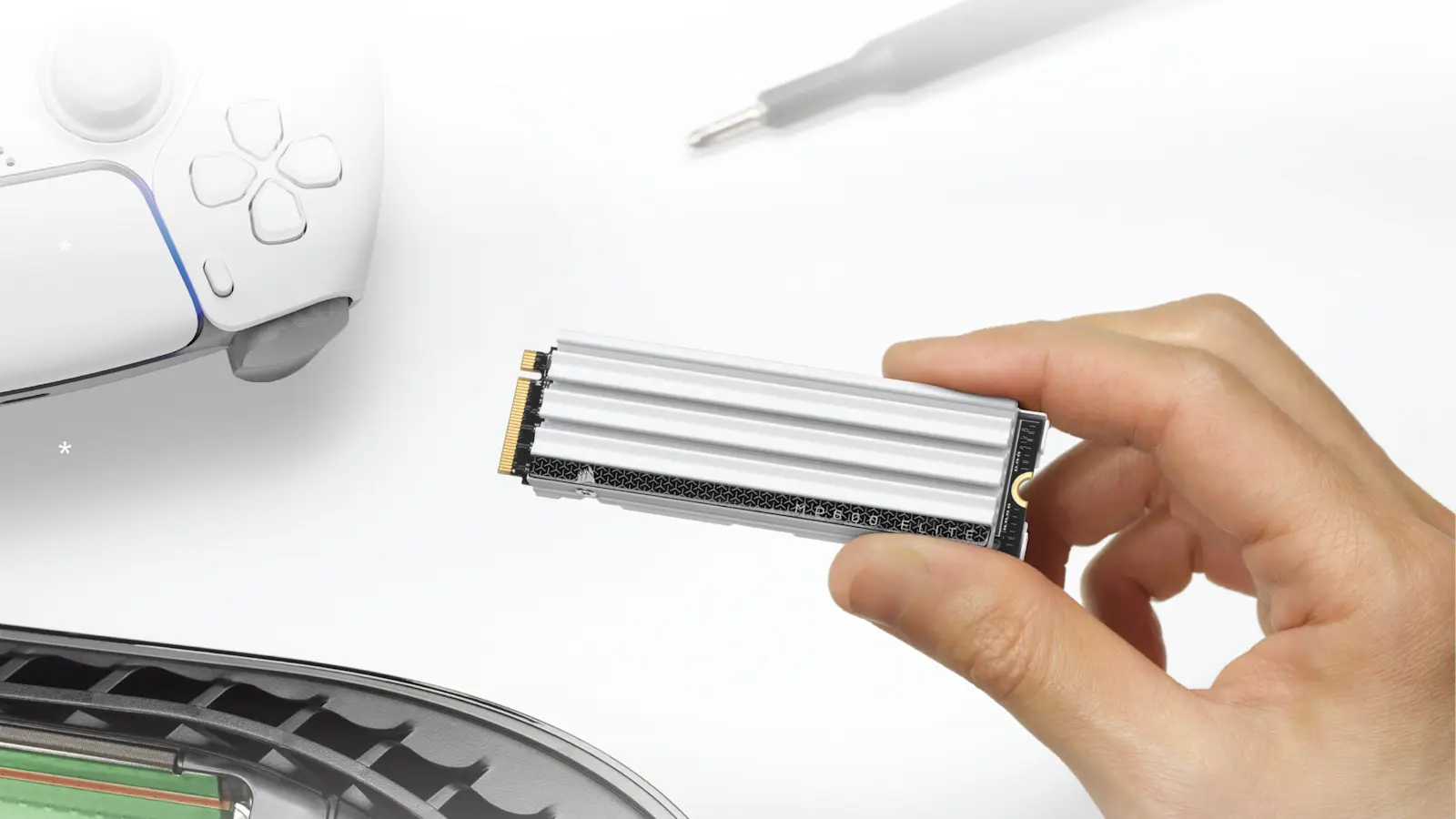 A hand holds a white-heatsink Corsair MP600 Elite SSD above an open PS5 console, next to a white controller.