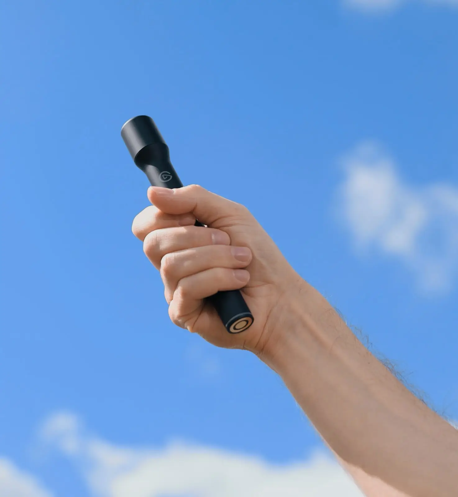 The black Elgato Wave Go Smart Handle on a white background: a slim handheld body with a lit button ring near the top and a wider head.