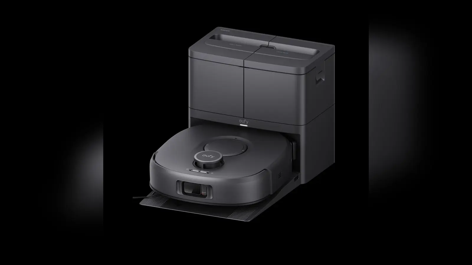 A black robot vacuum and mop on its docking station shown from the front, centered on a dark background.