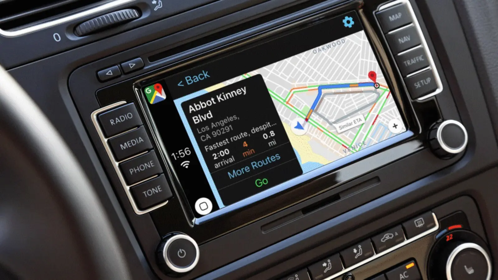 A car dashboard screen showing Google Maps on Apple CarPlay with a route to Abbot Kinney Blvd in Los Angeles.
