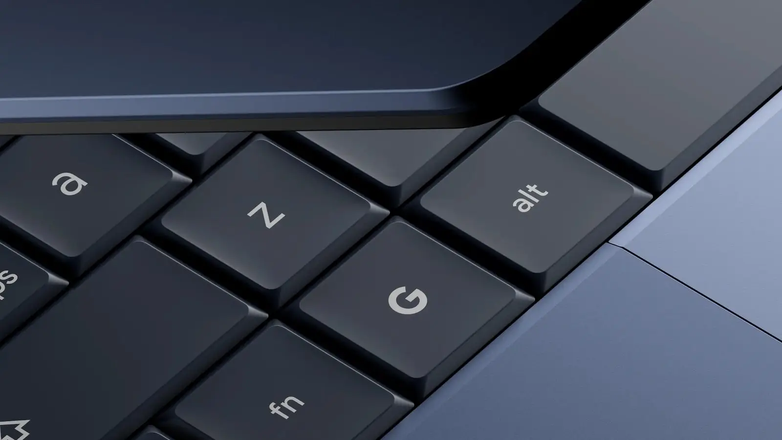 Close-up of a Googlebook keyboard in dark blue with a Google G key beside the alt and fn keys and the trackpad edge.