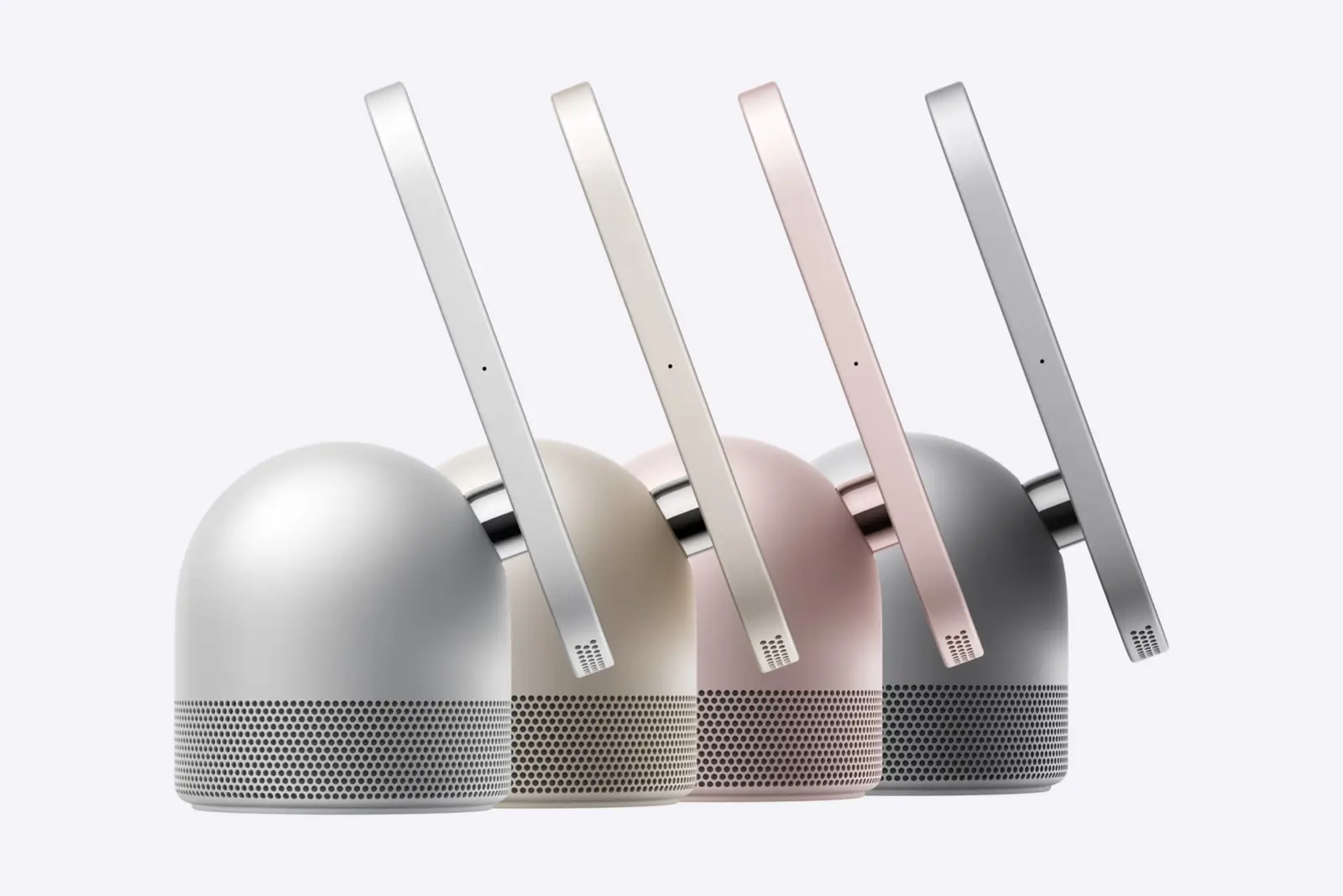 Four Apple HomeView displays seen side-on at an angle on domed speaker bases, in silver, starlight, rose pink and space gray, on a plain light background.