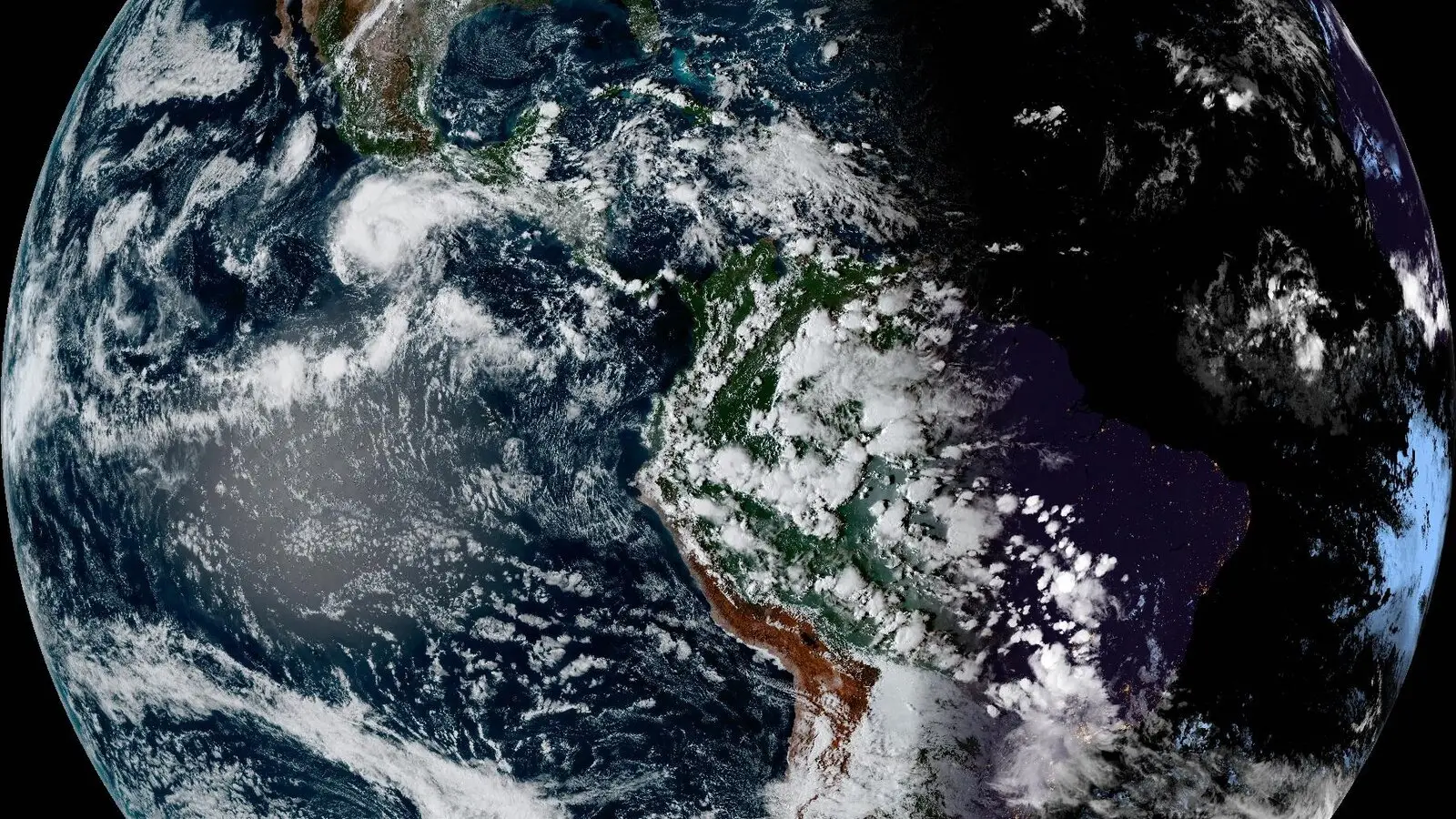 GOES-19 satellite view of the Americas, with cloud swirls over the Pacific and the night side of Earth on the right.