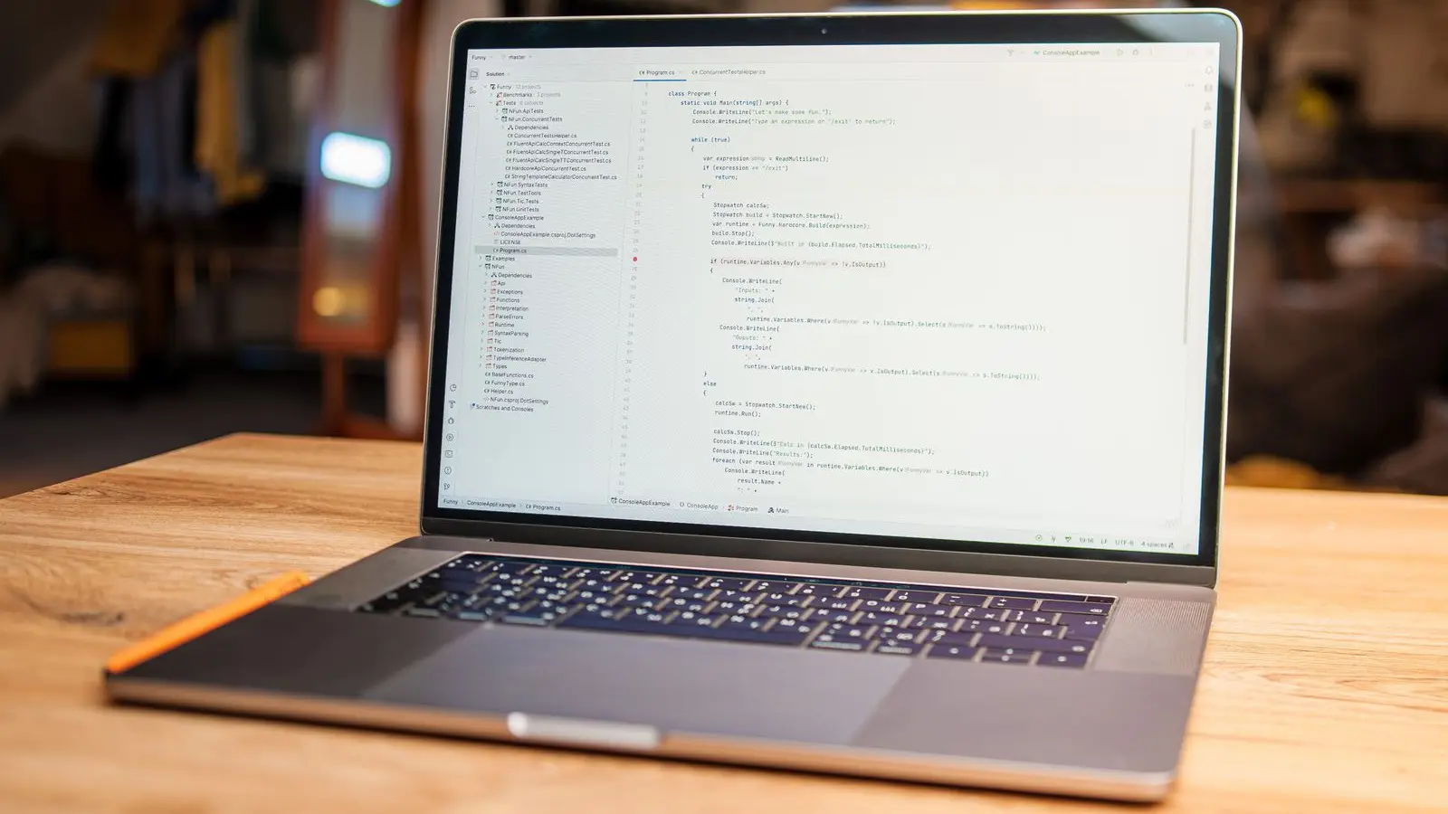 A laptop on a desk showing lines of code on its screen.