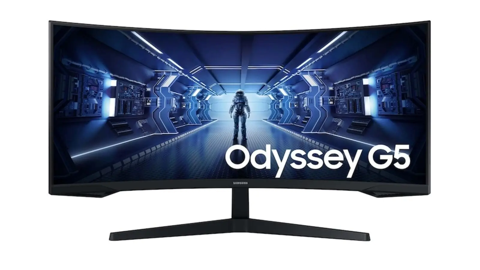 A front view of a black 34-inch curved Samsung Odyssey G5 monitor on a two-legged stand, showing an astronaut in a blue-lit corridor and the words Odyssey G5.