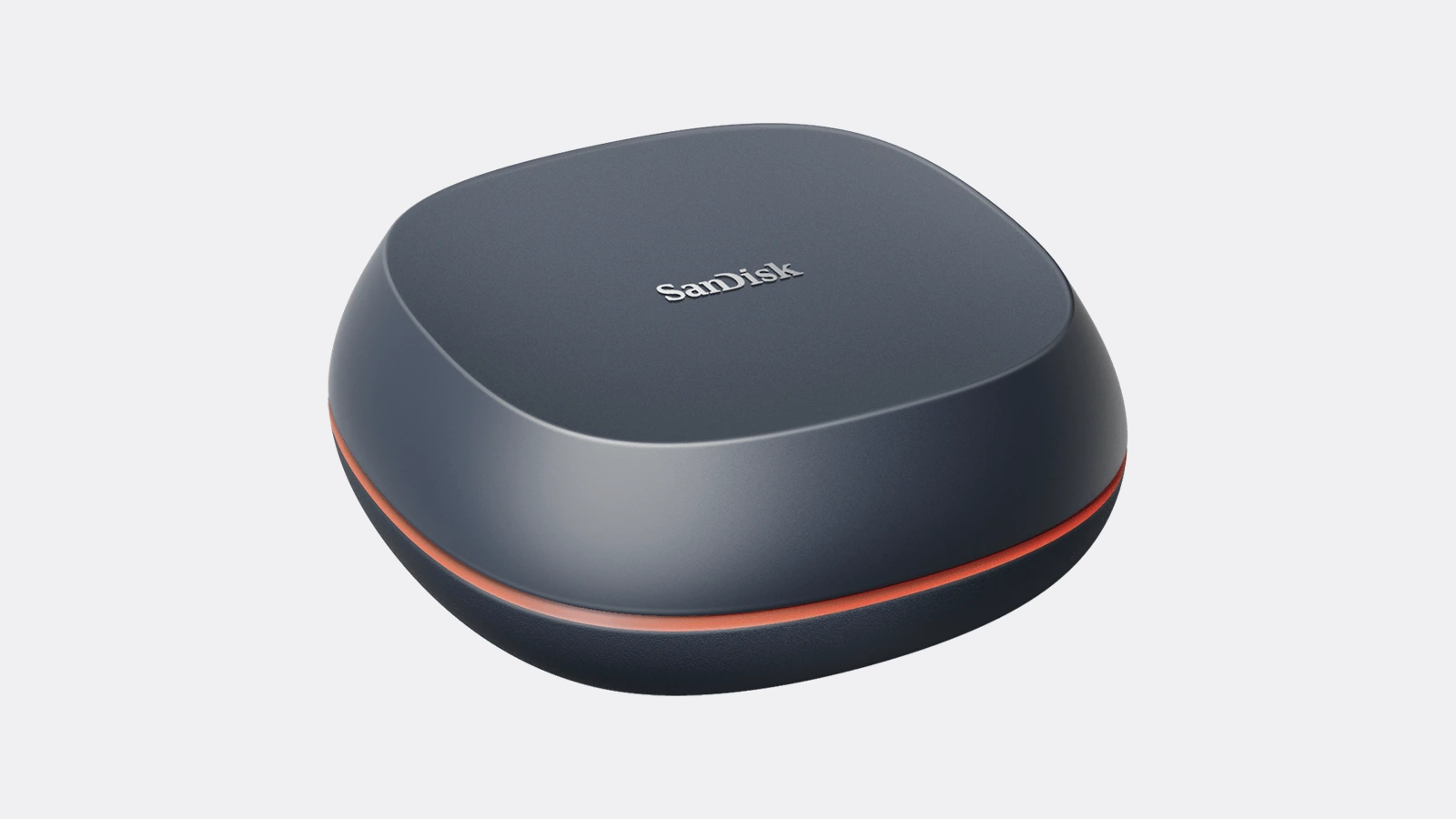 SanDisk Desk Drive desktop SSD, a dark grey rounded unit with an orange accent band and a SanDisk logo on top, seen at an angle on a plain light background.