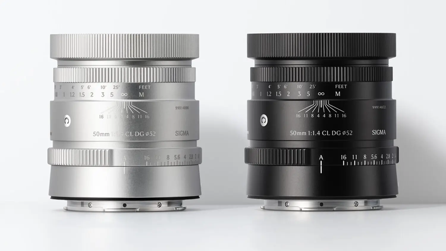 Two Sigma 50mm F1.4 CL DG lenses side by side, one silver and one black, with ribbed metal rings and distance scales.
