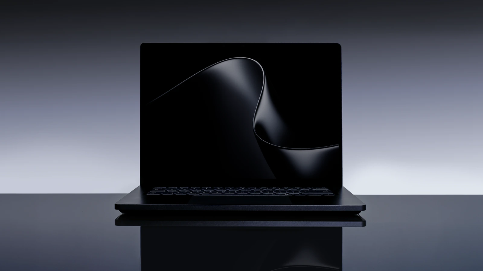 A black Surface Laptop Ultra, lid open and seen from the front, on a reflective dark surface against a grey gradient background, with an abstract dark wave on the screen.