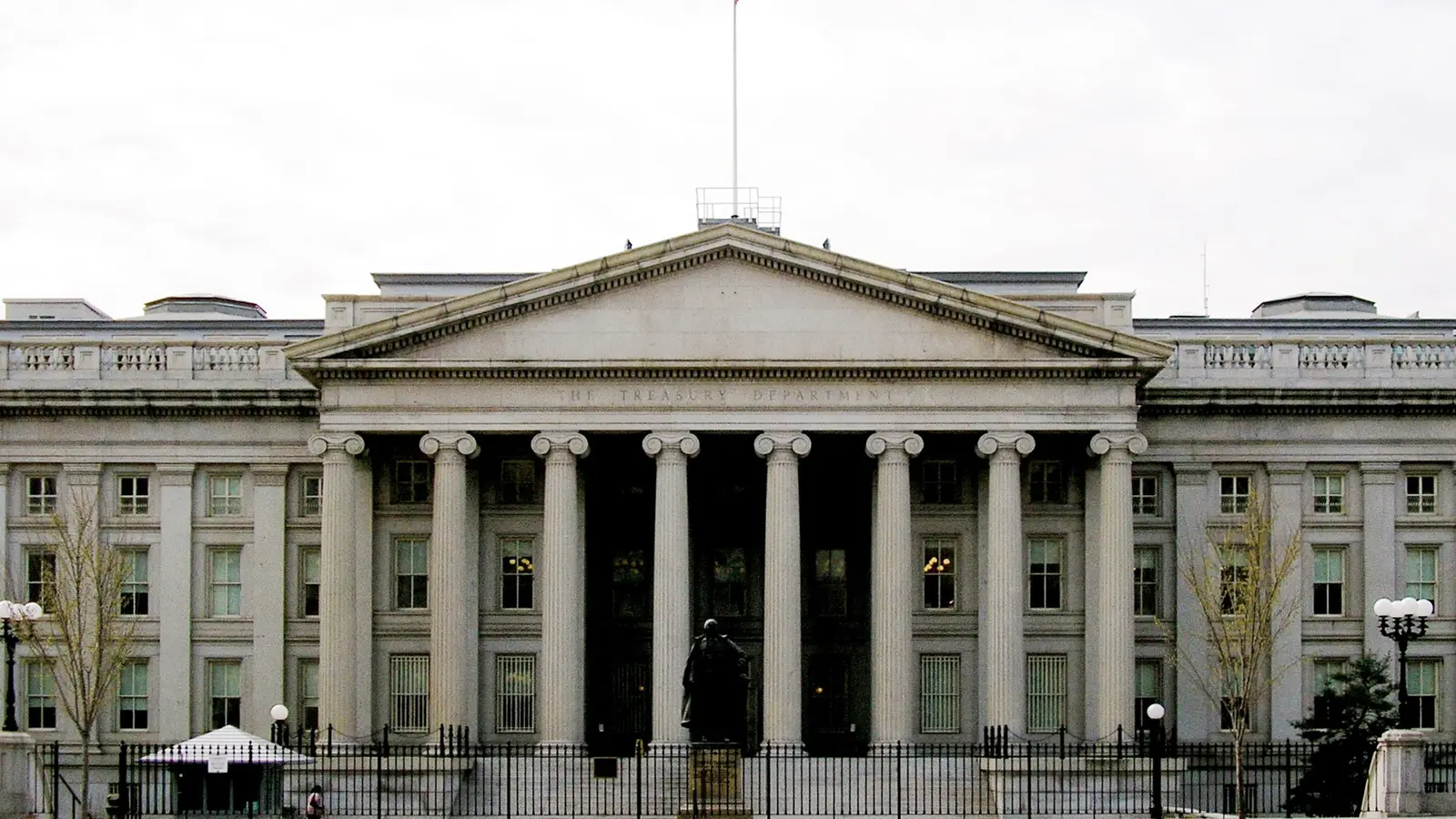 The columned front of the U.S. Treasury Department building in Washington under an overcast sky.