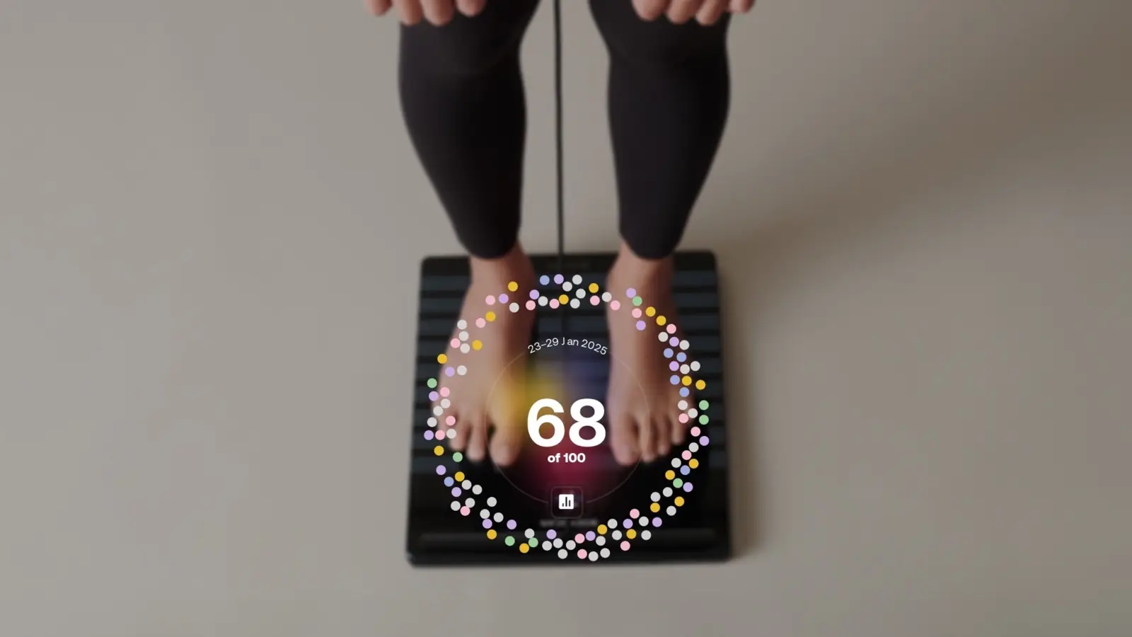Withings image of a person standing barefoot on a Withings scale, with a circular score of 68 of 100 shown over their feet.