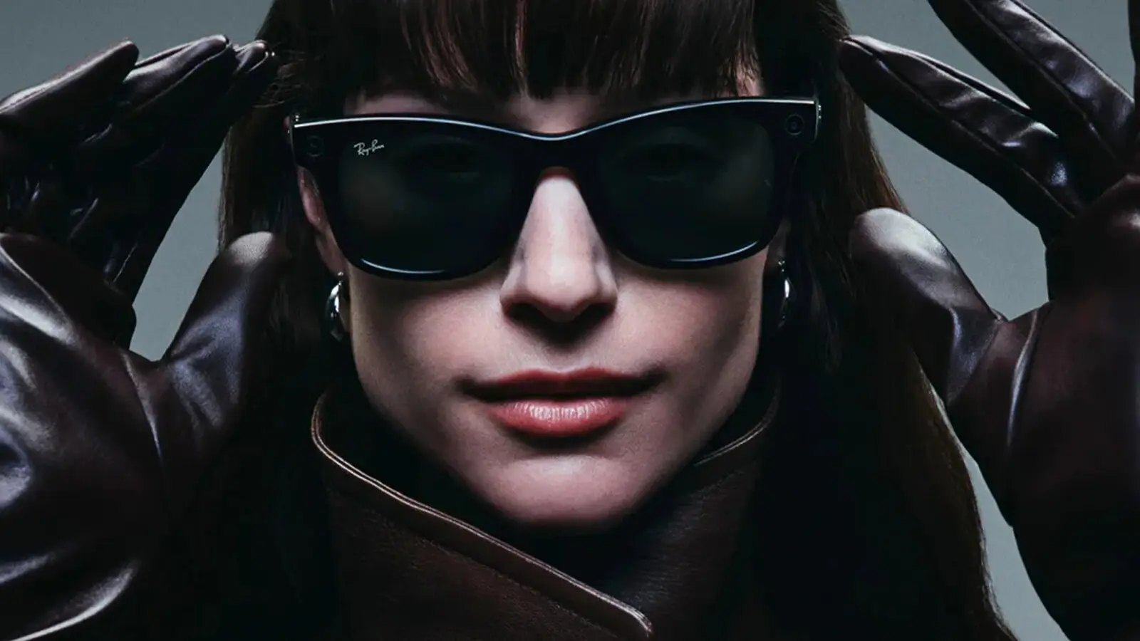 A model in black Ray-Ban Meta glasses and leather gloves, a camera lens visible on the frame