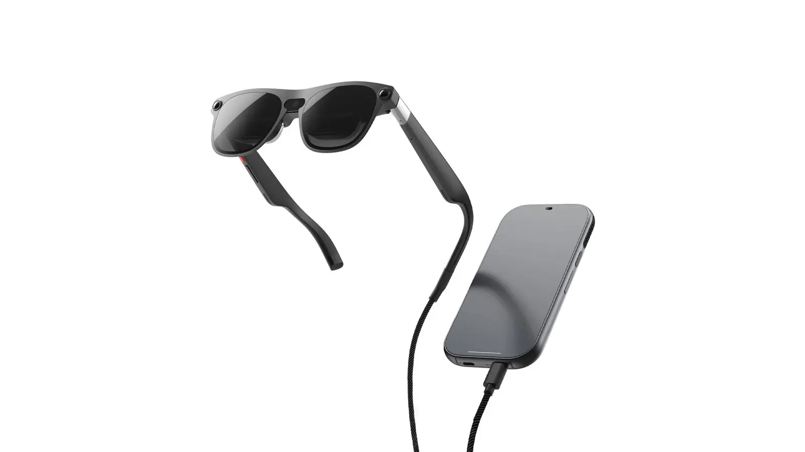 XREAL Aura Android XR glasses shown with the connected puck, linked by a USB-C cable.
